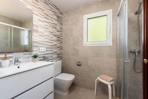 a bathroom with a toilet and a sink and a shower at Villa Catalina by Escape Home in Alaior