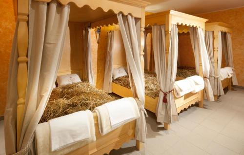 a group of beds in a room with hay at Clarion Congress Hotel Olomouc in Olomouc