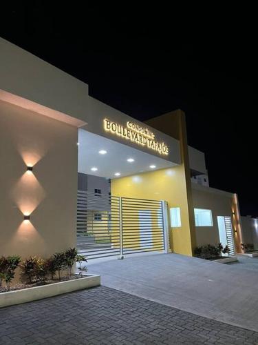 a building with a sign on the front of it at Apê tapajós in Santarém