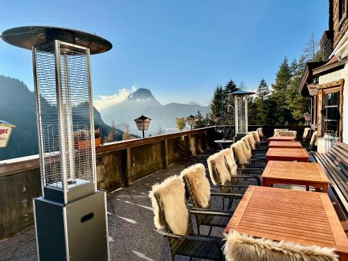 a row of tables and chairs on a balcony at Veitenhof im Kaisertal, nur nach 30 minütigem Spaziergang erreichbar, only after 30 minutes walk reachable in Ebbs