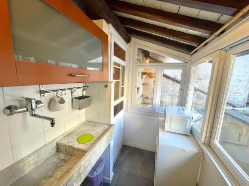 a small bathroom with a sink and a window at Trastevere Lovely Loft in Rome