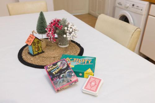 a table with books and a christmas tree on it at Vienna City Center Hostel in Vienna