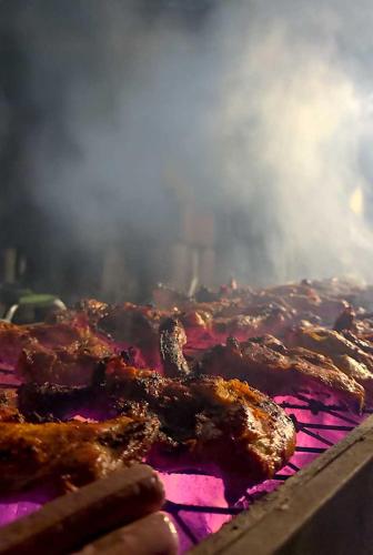 a close up of a grill with meat on it at The Out in Sinādil
