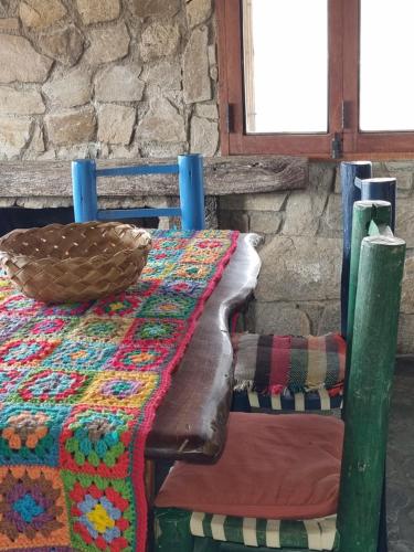 a wooden table with a colorful table cloth on it at Estancia Altos del Durazno in Estancia Grande