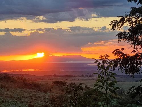 a sunset in the desert with the sun setting at Estancia Altos del Durazno in Estancia Grande