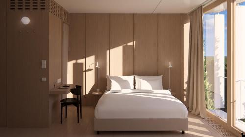 a bedroom with a large white bed and a desk at Das Kaya Design Hotel I Stuttgart Airport Messe in Filderstadt