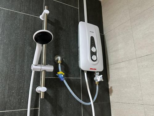 an electronic device is plugged into a wall at Admiral 3-Bedroom Retreat in Kota Laksamana Jonker in Melaka