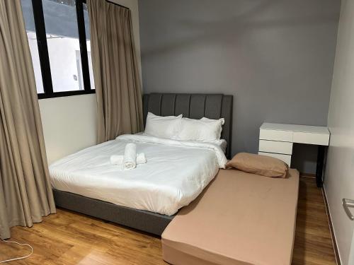 a small bedroom with a bed and a window at Admiral 3-Bedroom Retreat in Kota Laksamana Jonker in Melaka