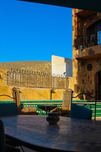 a table and chairs in front of a building at Panorama Guesthouse in Agadir