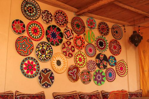 a wall with many plates on the wall at Panorama Guesthouse in Agadir