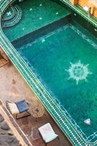 an overhead view of a swimming pool with chairs and a table at Panorama Guesthouse in Agadir