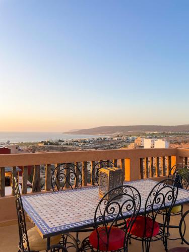 a table on a balcony with a view of the ocean at Panorama Guesthouse in Agadir