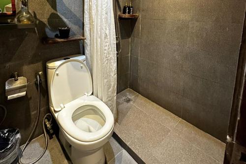 a bathroom with a white toilet in a stall at Sirom Beach House in Tambobong