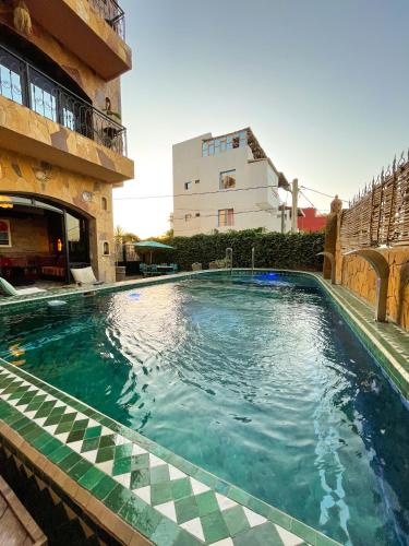 a swimming pool in the middle of a building at Panorama Guesthouse in Agadir