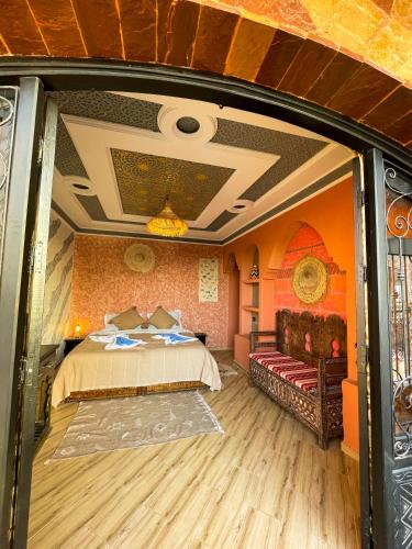 a bedroom with a bed and a couch in a room at Panorama Guesthouse in Agadir