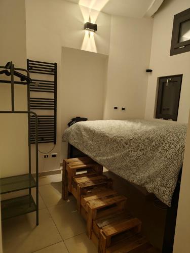 a room with a bed with wooden stairs and a light at Il nido di Luna in Turin