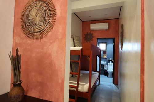 a hallway with a room with a bunk bed at Sirom Beach House in Tambobong