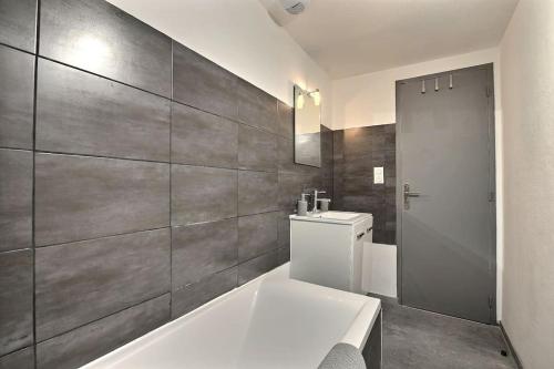une salle de bain avec une baignoire, des toilettes et un lavabo dans l'établissement Élégance Urbaine, à Belfort