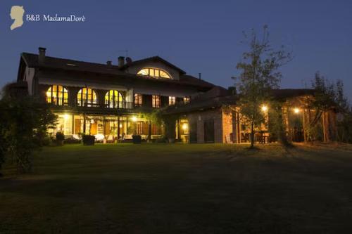 a large building with lit up windows at night at BeB MadamaDorè in Andezeno
