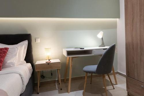 a bedroom with a desk with a chair and a bed at Urban Maisons in Athens