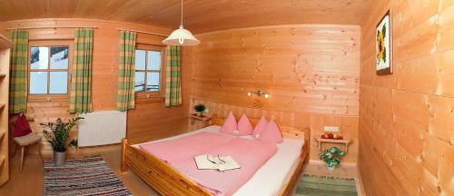 a bedroom with a bed in a wooden room at Landhaus Schiestl in Mayrhofen