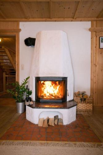 a fireplace in a living room with a fire at Landhaus Schiestl in Mayrhofen