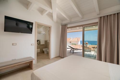 a bedroom with a view of the ocean at Margaida Boutique Hotel & SPA in Cala Gonone