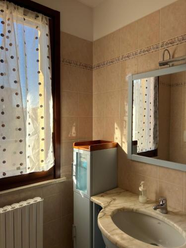 a bathroom with a sink and a mirror at Appartamento Bi locale Giusy in SantʼAntonio