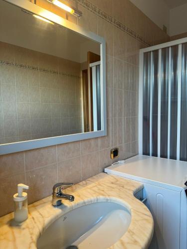 a bathroom with a sink and a mirror at Appartamento Bi locale Giusy in SantʼAntonio