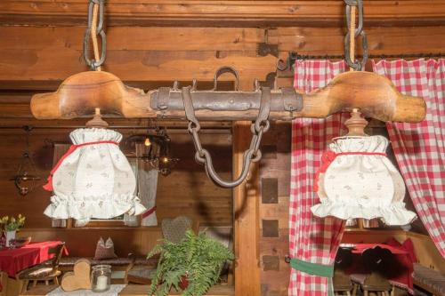 a kitchen with two chandaliers and two lights at Almstüberl - Schiestl's Ferienhütten in Mayrhofen