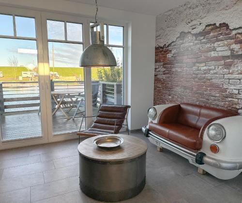 a living room with a couch and a coffee table at Fischerhäuschen am Kurpark in Neuharlingersiel