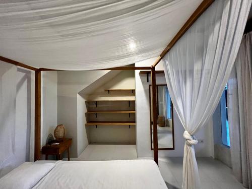 an attic bedroom with a bed and a staircase at Base Villa in Canggu