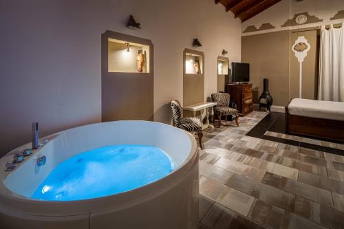 a bathroom with a large tub in a room at Le Meraviglie di Alice in Cagliari