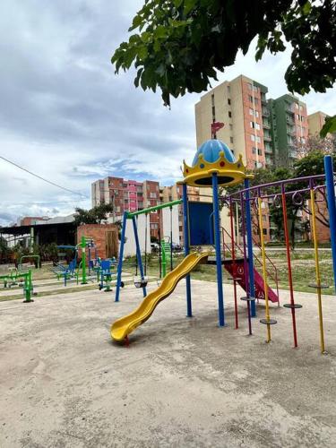 a playground with a slide in a park at Bonito apartamento 3 habitaciones, 4 camas in Cúcuta