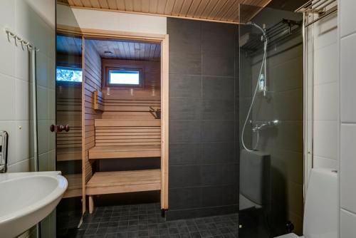 a bathroom with a shower and a sink and a tub at Rukankarhu Apartment in Ruka