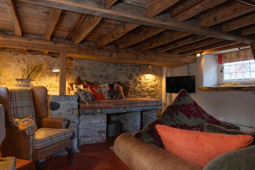 a living room with a couch and a fireplace at Gileston Manor-Self catering in Saint Athans