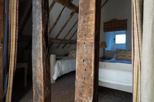 a bedroom with a bunk bed and a mirror at Gileston Manor-Self catering in Saint Athans