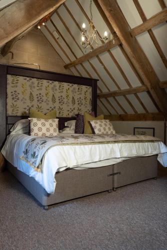 a bedroom with a large bed in a attic at Gileston Manor-Self catering in Saint Athans