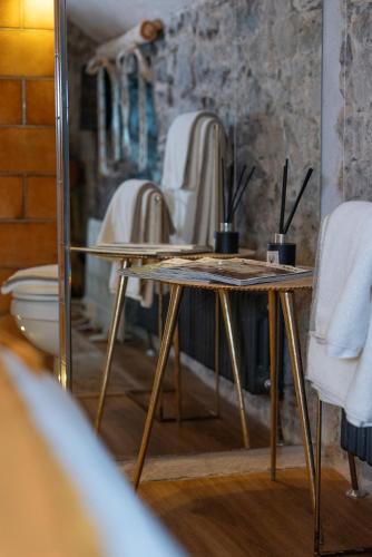a table in a room with a mirror at Gileston Manor-Self catering in Saint Athans