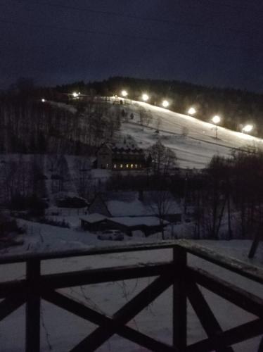 a view of a snow covered field at night at Górskie Zacisze Kamienica in Stronie Śląskie
