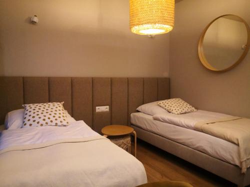a room with two beds and a mirror at Klimatyczne pokoje na Ligonia in Turza Śląska