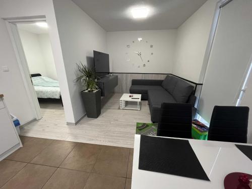 a living room with a couch and a table at Apartment Romeo & Julija, Near terme Olimia, Free Parking in Podčetrtek