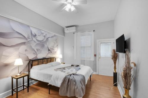 a bedroom with a bed with a flower mural on the wall at Charming 2br Near Drexel in Philadelphia