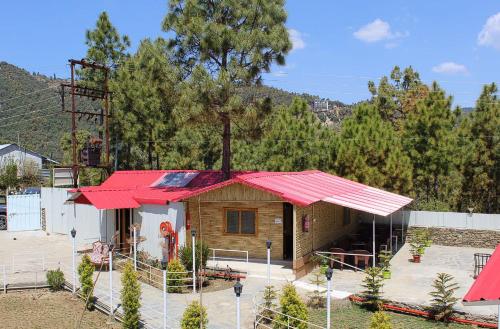 a small house with a red roof at The Chail Heights Hotel and Resort in Chail
