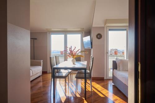 a dining room with a table and a couch at Milan Retreats in Milan