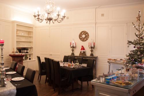 a dining room with a table and a christmas tree at Chateau de l Aviette - Rancennes in Givet