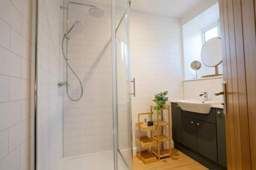 a bathroom with a shower and a sink at Monsal Trail Apartment A, Bakewell in Hassop