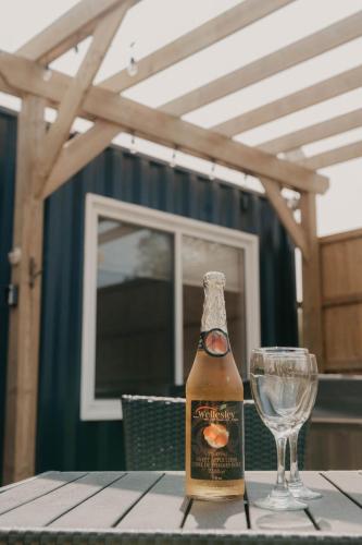 a bottle of beer and a glass on a table at Inner Joy Getaways in Elora