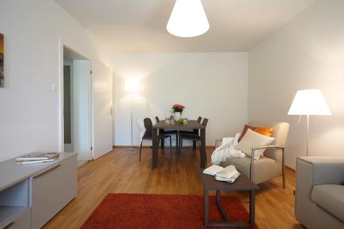 a living room with a table and a couch at CITY STAY - Nordstrasse in Zürich