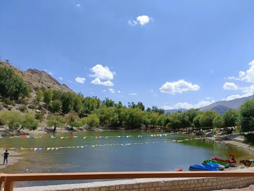a river with a bunch of people in the water at Lakeside Nako Hotel & Restaurant in Nako